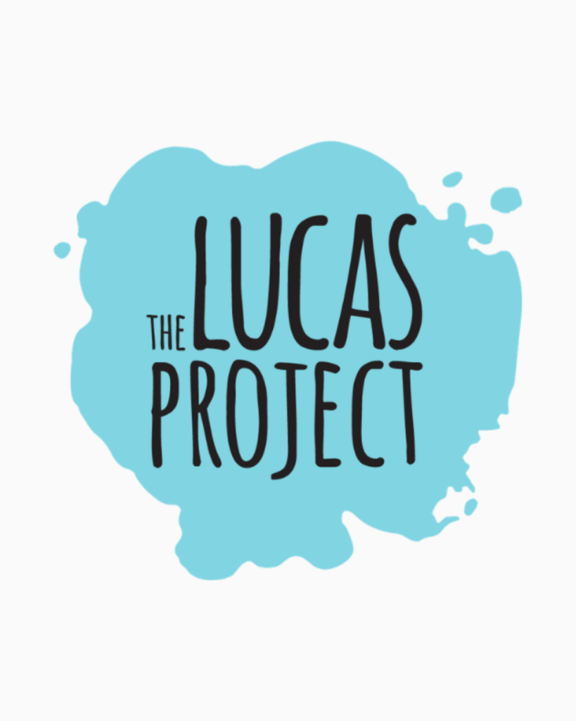 Logo for The Lucas Project on an ivory background. The logo is a light sky blue paint splatter with grey lettering that reads "The Lucas Project"